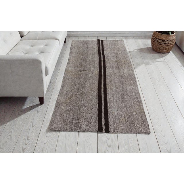 This is a vintage Turkish Oushak rug from the Mid 20th Century. The piece was hand-knotted.