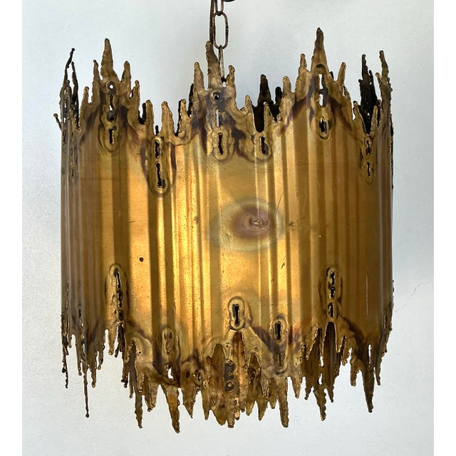 This exceptional vintage chandelier is a quintessential masterpiece by Tom Greene, showcasing the raw, expressive power of...