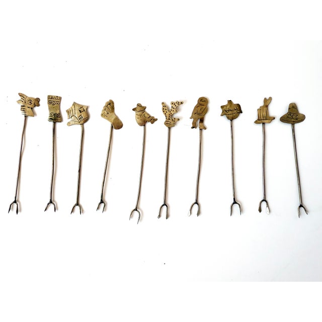 Charming set of ten handmade Mexican silver picks, each topped with a unique Southwest-themed finial: cactus, man in the...