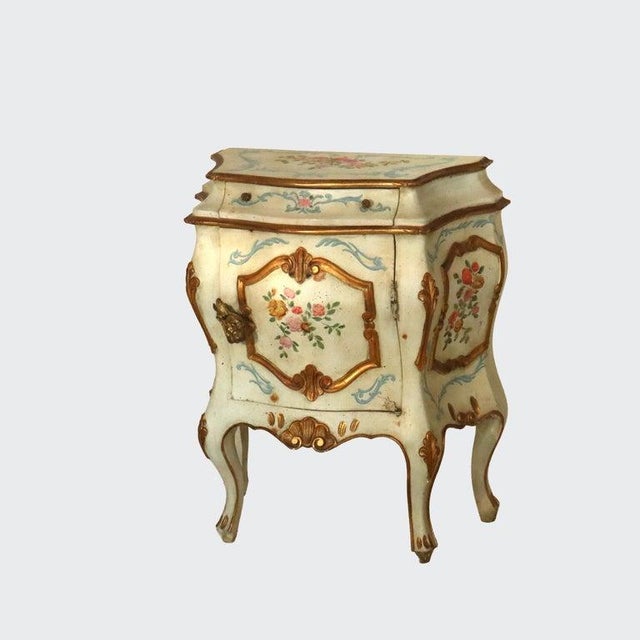 A French Rococo Style Bombay side stand, dating to the 20th Century. The piece features a hand-painted wood construction...