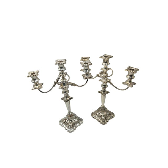 This pair of three-light candelabras reflects the refined aesthetic of the Neoclassical Revival movement of the early 20th...