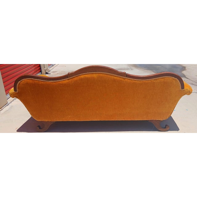 Gorgeous mid century camelback sofa, fits three comfortably. Detailed floral carvings, in very good condition, Kept in a...