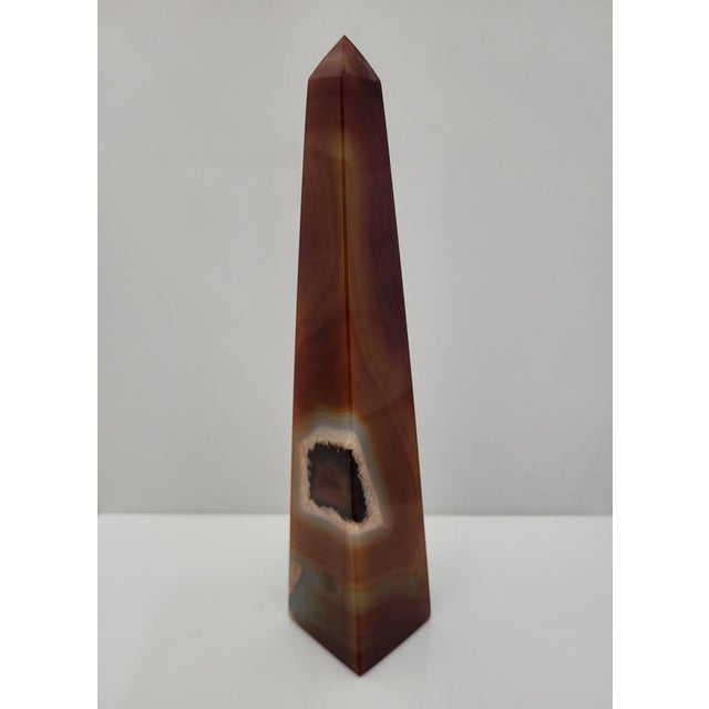 Carnelian Agate crystal tower featuring polished banded layers and a distinctive natural druzy pocket. Carnelian is a...