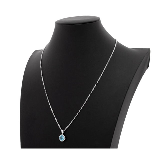14K White Gold Blue Topaz and Diamond Pendant Necklace, featuring one prong set cushion brilliant cut blue topaz weighing...