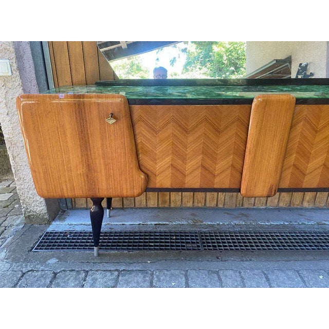 "Italian sideboard Circa 60" Italian sideboard in rosewood veneer, glass top decorated with green marble, four doors and a...