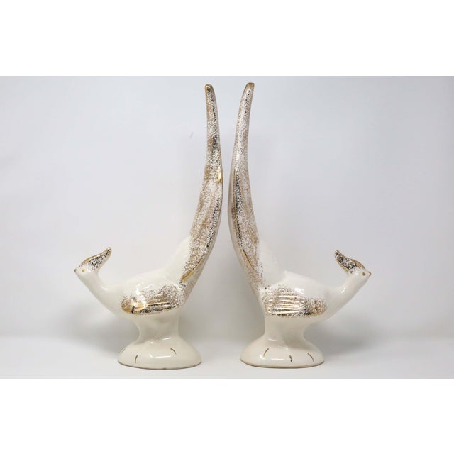 A pair of mid-century ceramic pheasants, with a tall, sculptural form and ivory white /gold speckle glazes. Good...