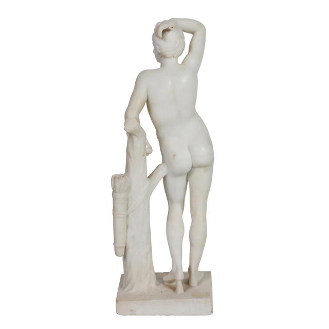 Neo-classical Thassos marble statue of male youth leaning against carved tree trunk. Carved from one piece of marble. Very...