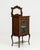 A tall, narrow Victorian cabinet designed for efficient storage within limited space. The simple proportions and...