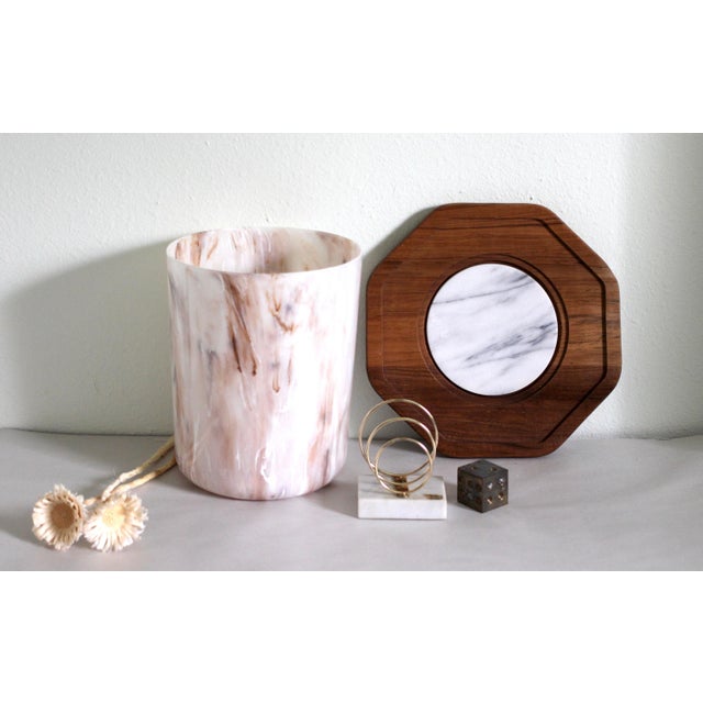 A very unique teak wood and marble cheese tray or cutting board. Has a circle marble design in the center of a teak...