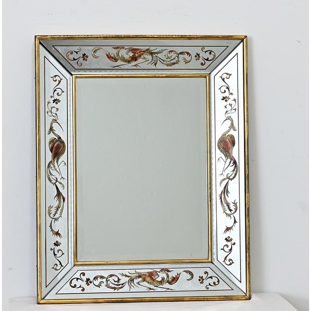 A dazzling French vintage mirror of églomisé design in the border panels featuring stylized herons and mythical phoenix...