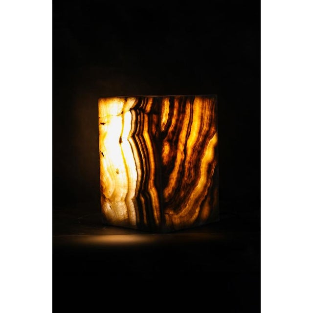 A sculptural side table pedestal carved from natural onyx, handcrafted by skilled artisans on the island of java. Its...
