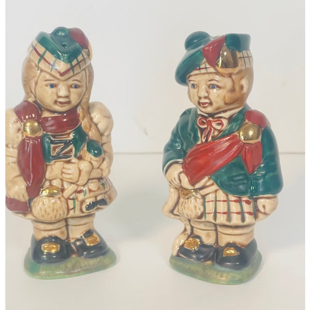Cute pair of vintage salt and pepper shakers of pair figurines in ethnographic costumes Irish/Scotish.