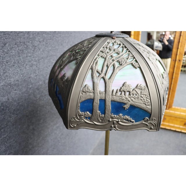 Miller slag lamp, brass & iron, circa 1910, metal work depicts lake scene.