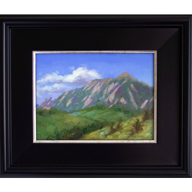 This oil on panel artwork captures the majestic Flatirons against a clear blue sky, showcasing the rugged beauty of the...
