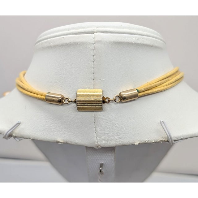 1980s goldtone one grey Lucite sea urchin shape with a round clear rhinestone center, one pink Lucite sea urchin shape...