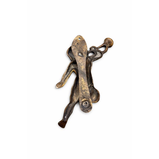 Charming vintage solid brass cherub door knocker featuring a classical putti form holding a trumpet. Beautifully aged...