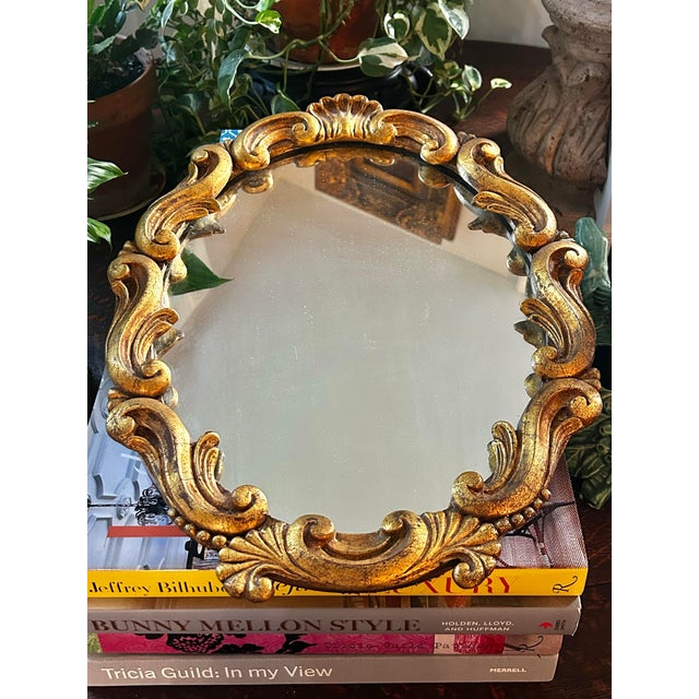 Bring timeless European elegance to any room with this beautifully hand-carved giltwood Rococo Revival wall mirror, dating...