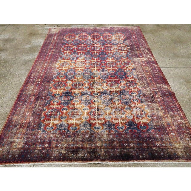 This mid-20th-century Central Asian Silk Turkoman tribal accent rug presents a richly patterned allover composition in...