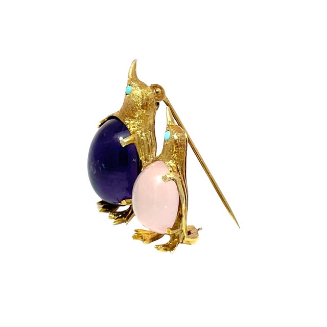 This exquisite vintage penguin brooch is a stunning piece crafted from stamped 14k yellow gold, weighing an impressive...