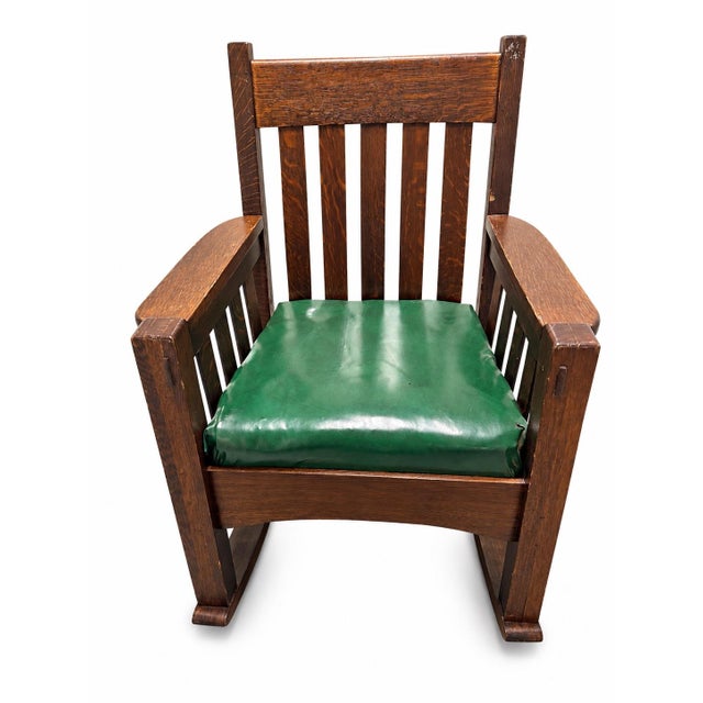 A handsome antique Mission oak rocking chair by The Harden Line of Camden, New York, dating to circa 1910. Richly figured...