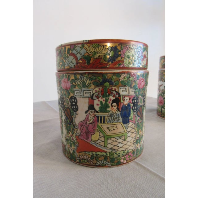 Pair of 1930s Asian cover jars with people motif.