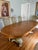 Elegant vintage nine-piece dining set featuring an oval satinwood extension dining table with 8 coordinating cane back...