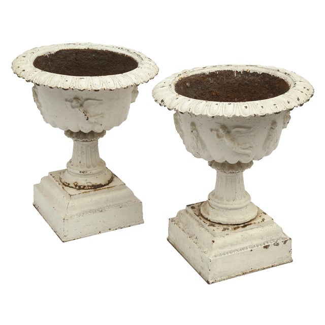A Beautiful Pair of Antique Cast Iron Garden Urns on an elegant pedestal. In Addition to the decorative edge, there are...