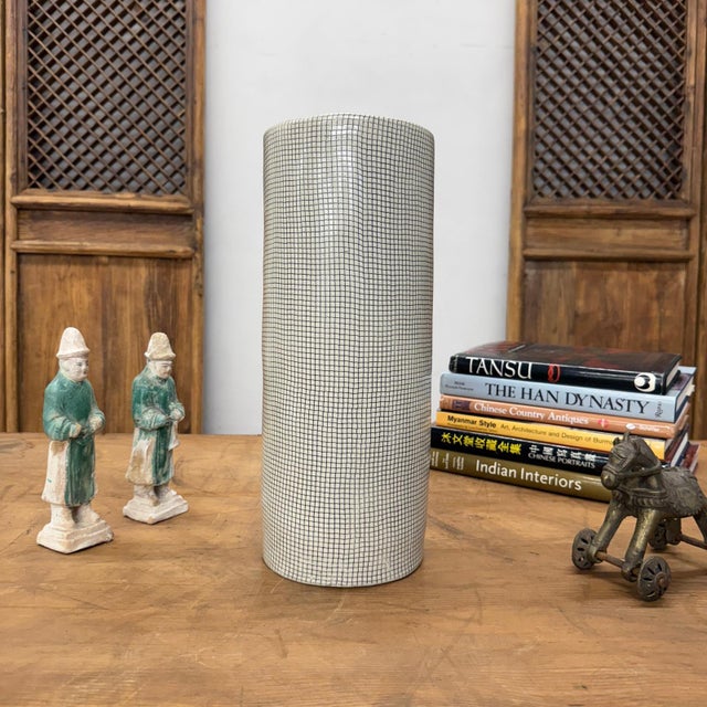 "About This Piece About This Piece If youre drawn to bold geometry and striking modern patterns, this tall ceramic vase...