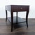 Elegant saber legs support a functional front drawer and shelf. The table is constructed from mozambique and mahogany...