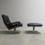 Remarks: King chair with hocker by André Vandenbeuck for Strässle, Switzerland 1960s. Black leather upholstery with steel...