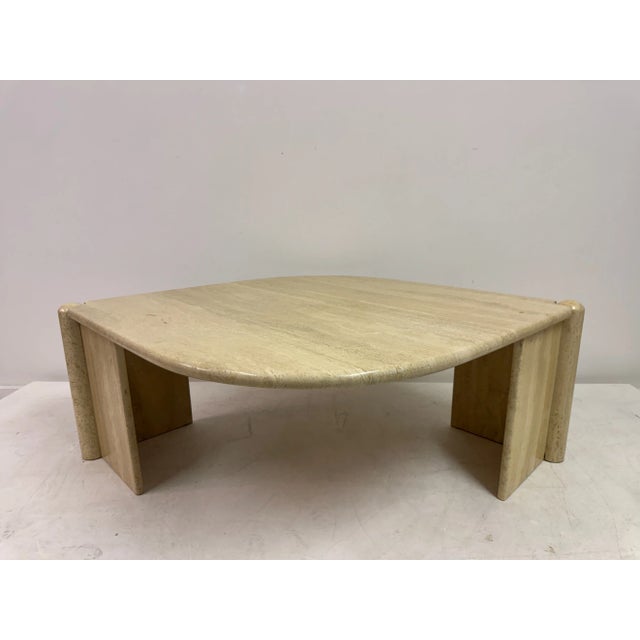 Eye-Shaped Travertine Coffee Table, 1980s Elegant and sculptural travertine coffee table from the 1980s, featuring an...