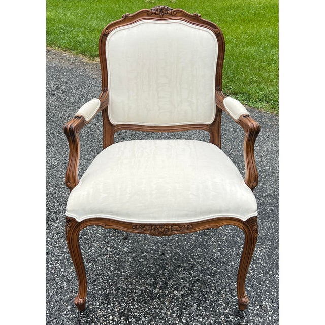 Classic Louis XV style armchair. Referred to as a fauteuil chair because of the open padded arms. Nicely carved crest and...