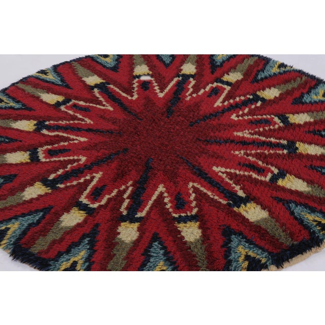 Hand-knotted in lush, high-pile wool in Sweden circa 1960-1970, this 5x5 vintage Swedish Rya circle rug is a bold new...