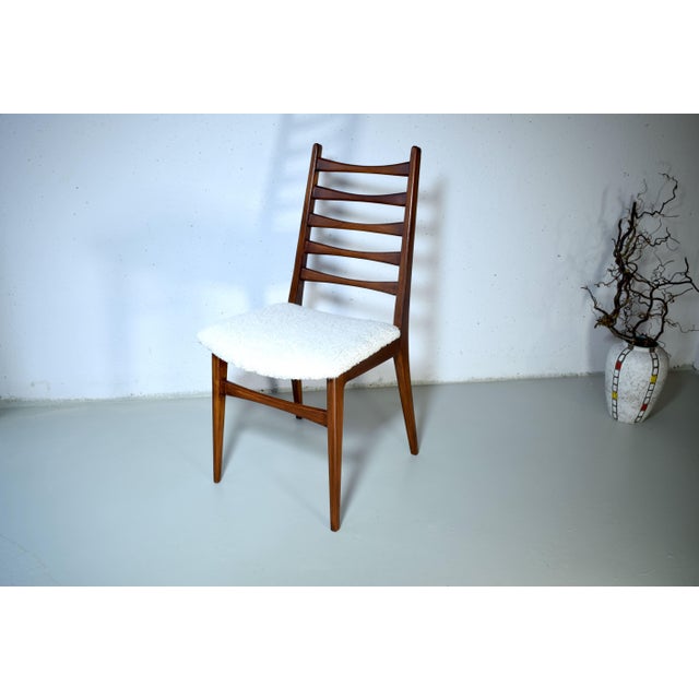 This is a Scandinavian chair from the 1960s. The elegant frame is made of walnut with five rounded spindles. The chair...