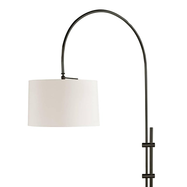 The juxtaposition of a metallic, adjustable base with a fabric shade gives this floor lamp a modern aesthetic—seamlessly...