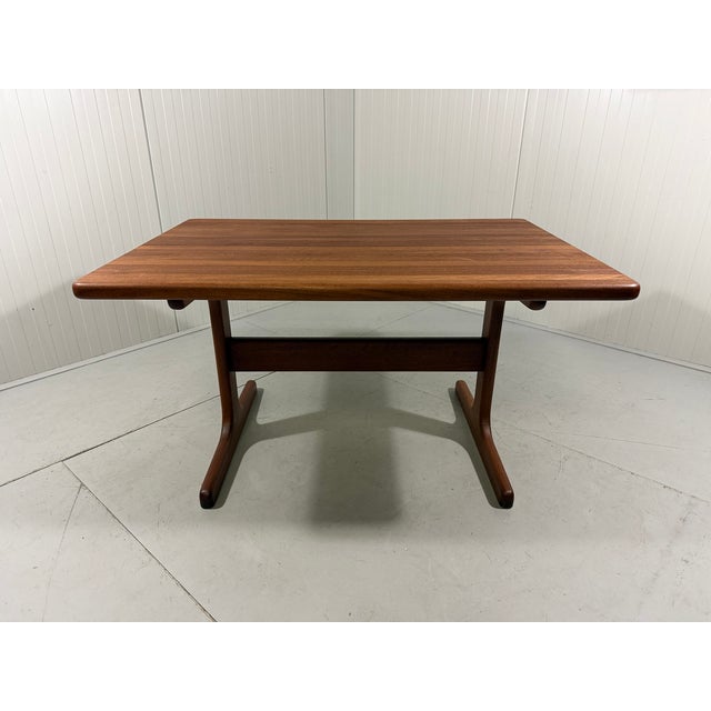 Beautiful sturdy rectangular dining table, Denmark. Thick solid teak wood with a warm patina. The tabletop is made from...