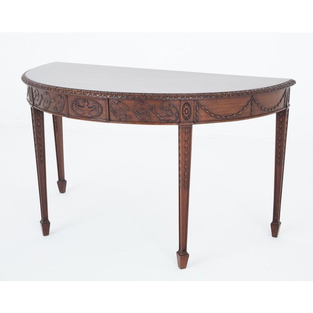 A good quality Adams style mahogany console table. Circa 1880 The table is raised upon tapered legs with hare bell carved...
