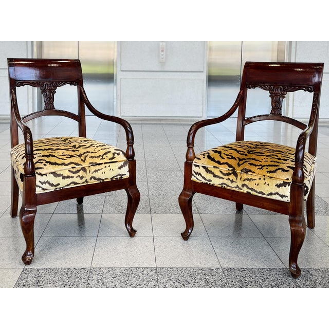 Hand-crafted in the Biedermeier Style in the Early 20th Century, these Danish mahogany armchairs have been refinished and...