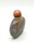 The small bottle is a very flattened round shape snuff bottle. This style of very flat snuff bottles was popular in the...