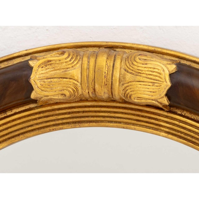 Regency Style Walnut and Giltwood Framed Circular Convex Mirror, with reeded and foliate design. 29.5" Diameter; overall:...