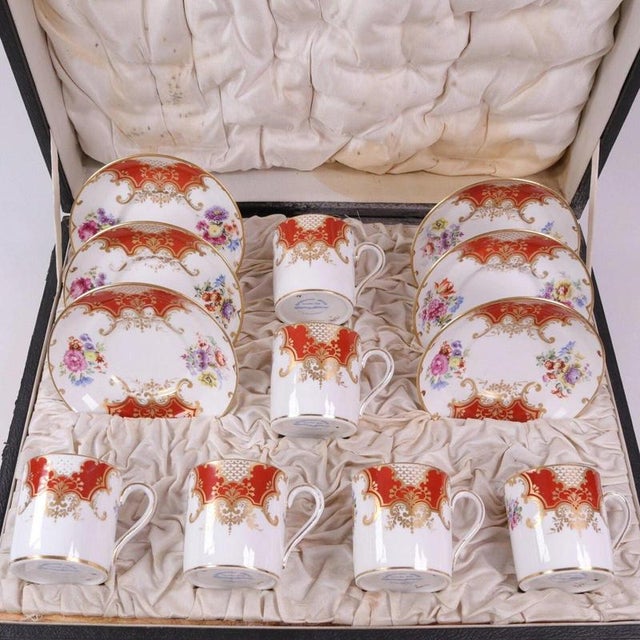 Flaring panels of burnt orange enamel frame delicate white fishscale grounds and polychrome floral sprigs across this six-...