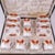 Flaring panels of burnt orange enamel frame delicate white fishscale grounds and polychrome floral sprigs across this six-...