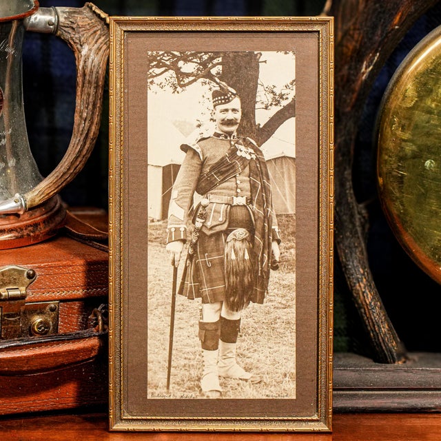 This striking framed photograph, dating to around 1918, captures a distinguished Pipe Major of the Liverpool Scottish...
