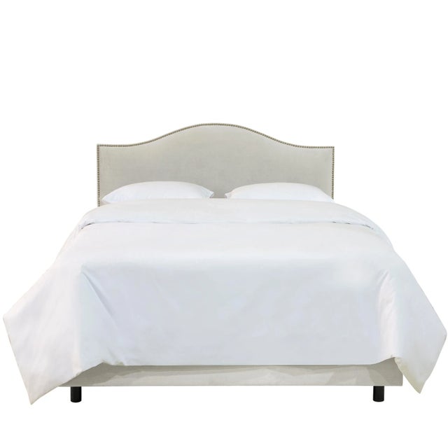 Give your interior a lift with this Upholstered Bed. Featuring the delicate curves of a classic camelback design, with...