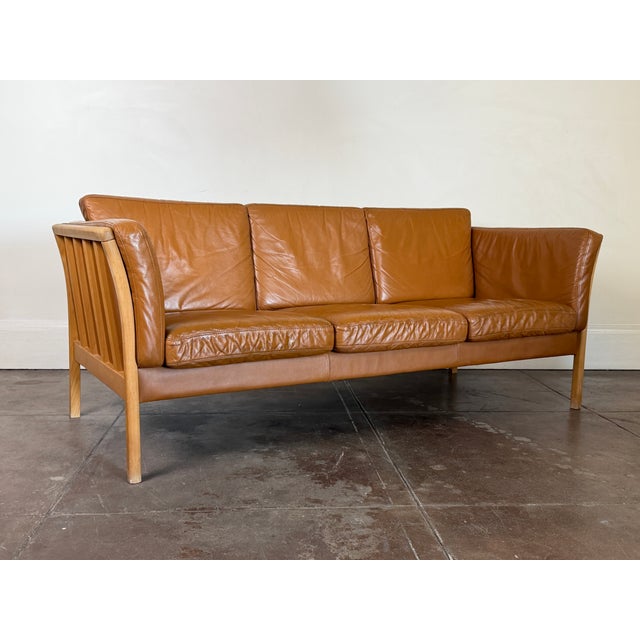 Beautiful Danish sofa by Skovby, combining supple tan leather upholstery with a solid beechwood frame. Unsigned. Good...