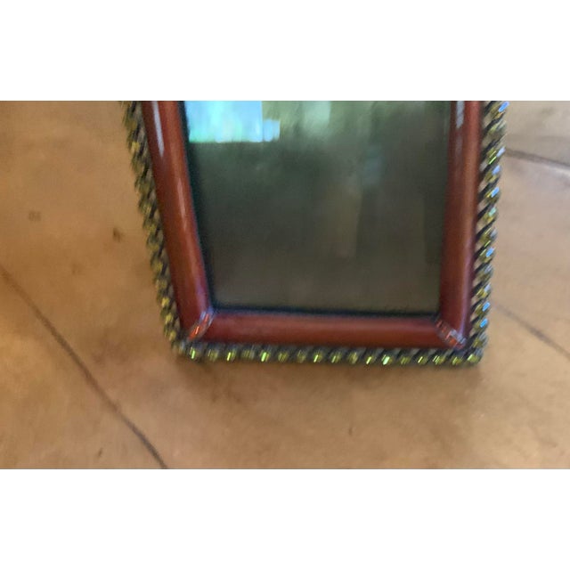 A simple classic and exquisite object framed with yellow Swarovski crystals and amber colored enamel. The perfect frame...