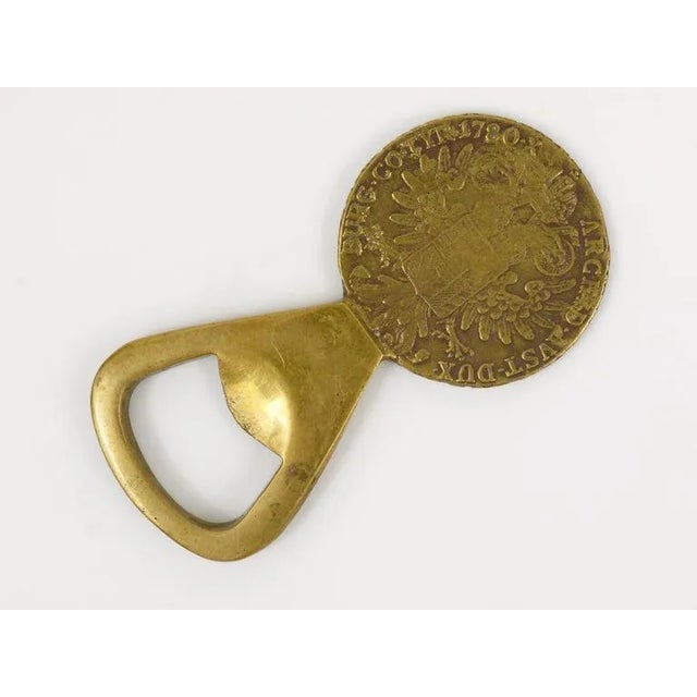 A beautiful brass coin bottle opener, designed and executed by Carl Aubock in the 1950s. In good condition with nice...