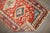 Full pile geometric antique northwest Persian runner with a red field bodied by colorful medallions, multiple borders and...