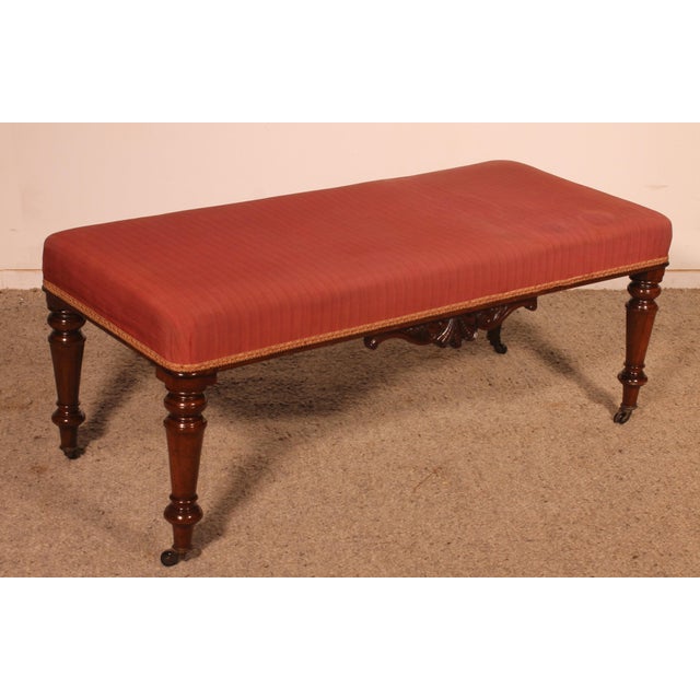 Exquisite 19th-century mahogany bench from England. Beautiful solid mahogany legs with elegant, simple turning, ending in...