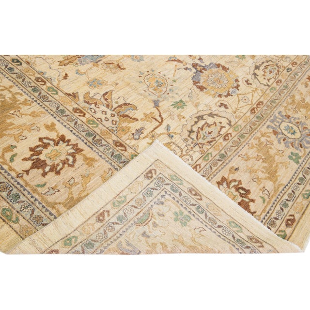 Beautiful modern Sultanabad hand-knotted wool rug with a beige color field. This rug has green, brown, and gray accents in...